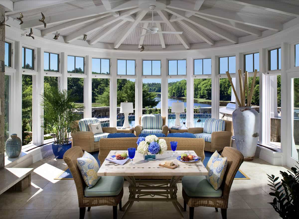 Circular Sunroom With Cathedral Ceiling, Wicker Furniture, and Panoramic River Views
