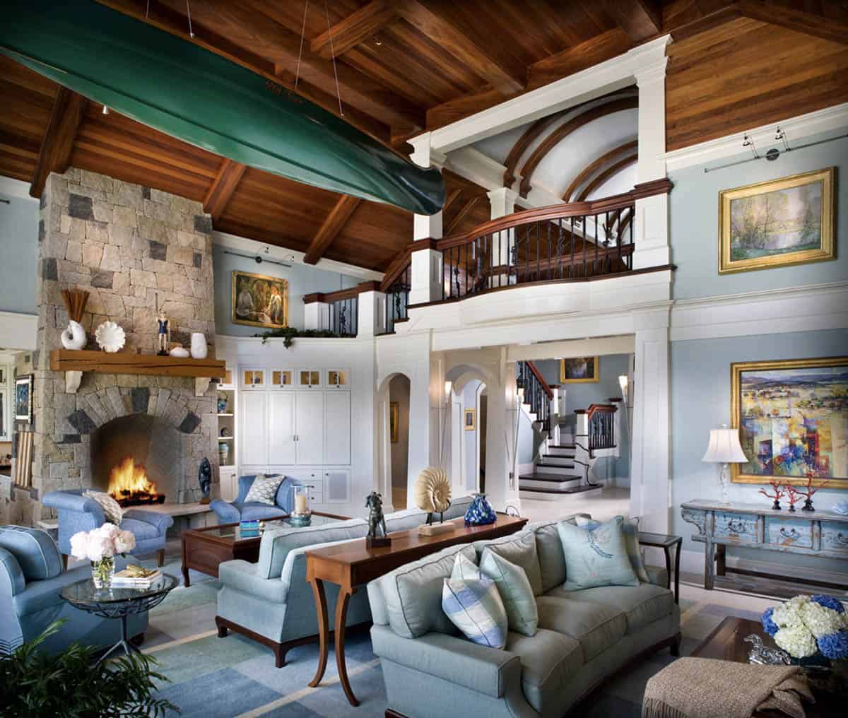 Great Room With Canoe Ceiling Display, Stone Fireplace, and Double-Height Wood Ceiling