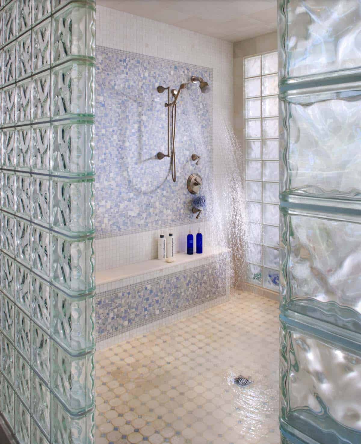 Walk-In Shower With Glass Block Walls, Blue Mosaic Tile, and Multiple Showerheads