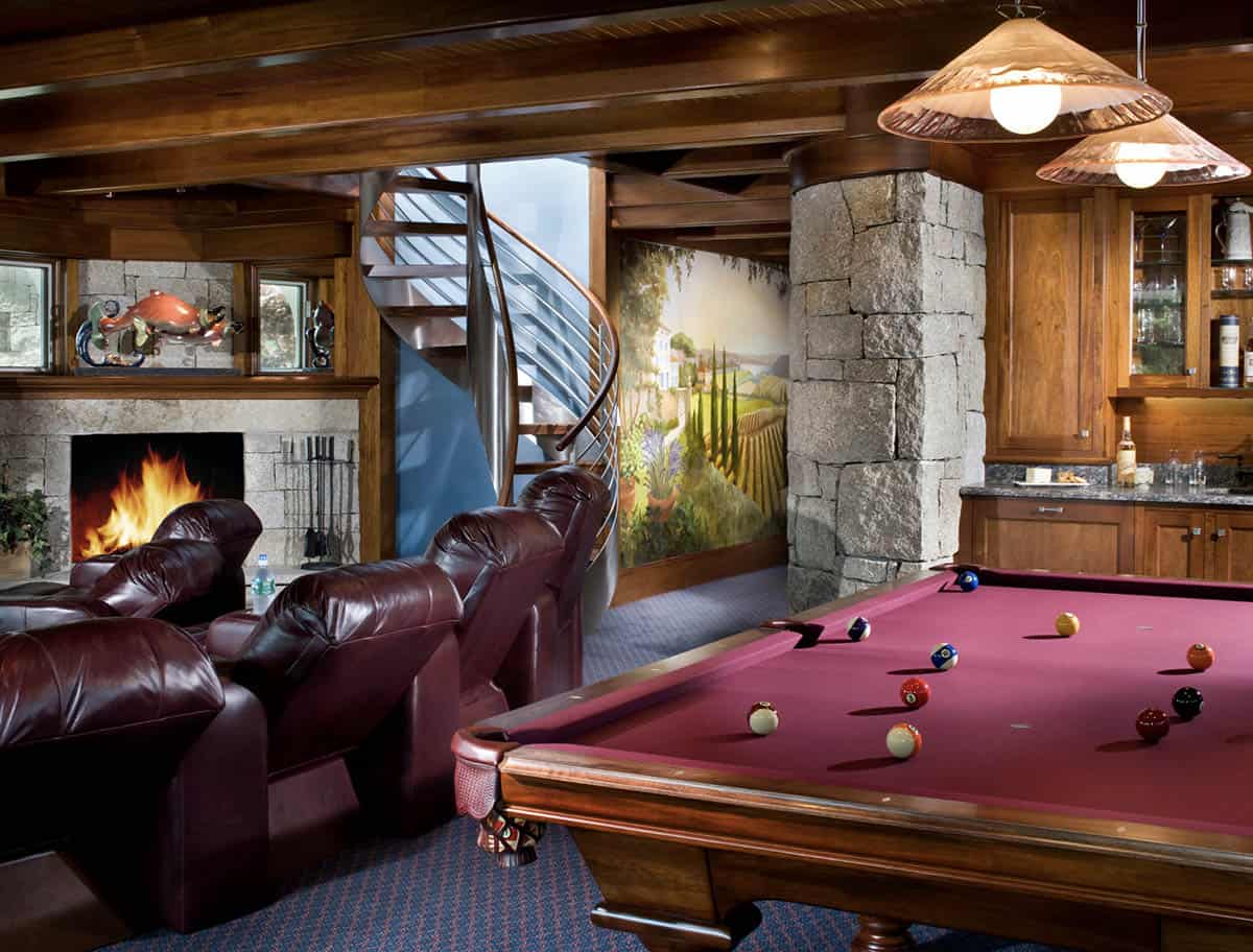 Lower Level Game Room With Pool Table, Stone Fireplace, and Spiral Staircase