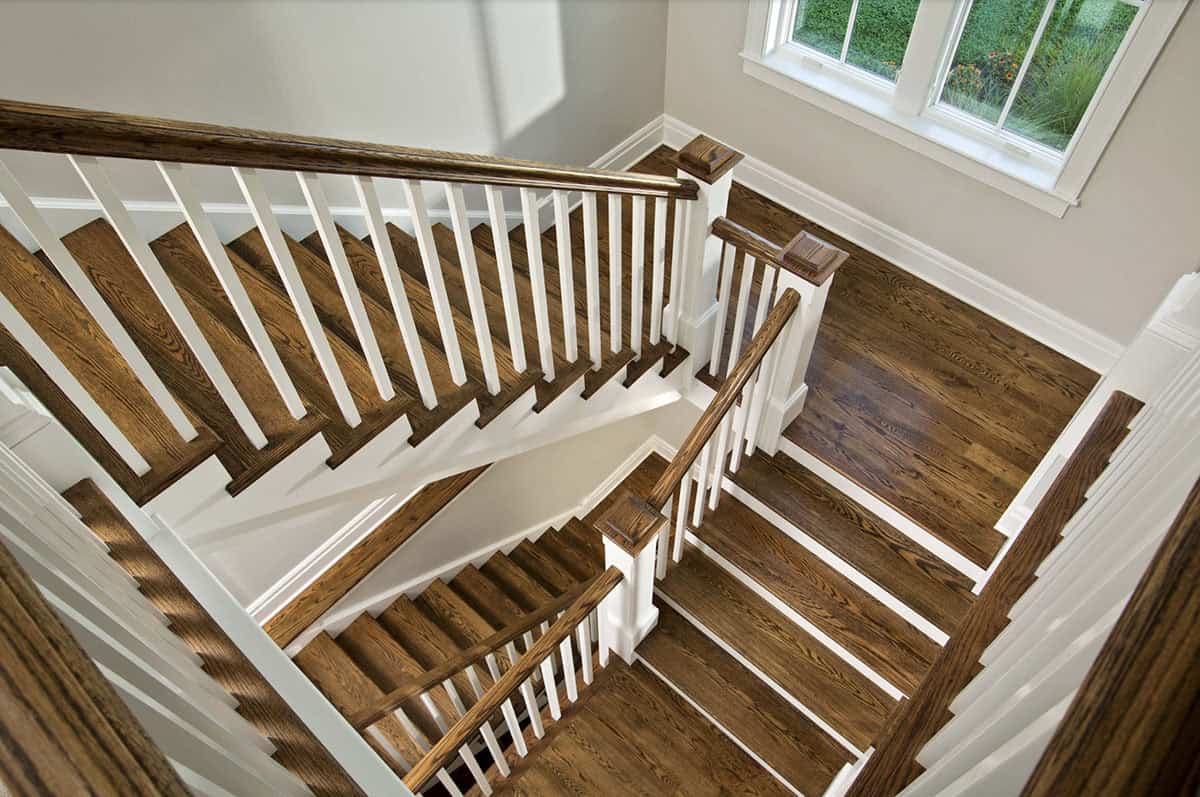 Overhead view of staircase with dark oak treads and white painted balusters