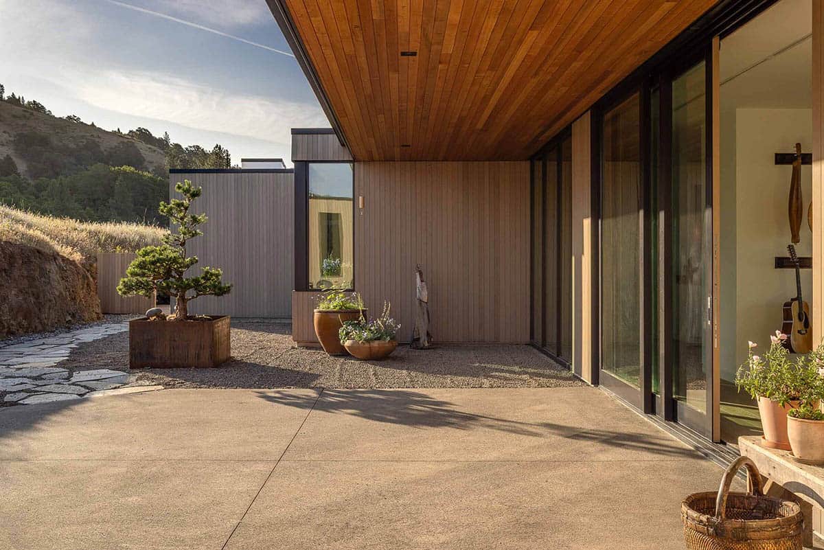 Courtyard patio with bonsai tree, gravel garden, and warm cedar-clad walls