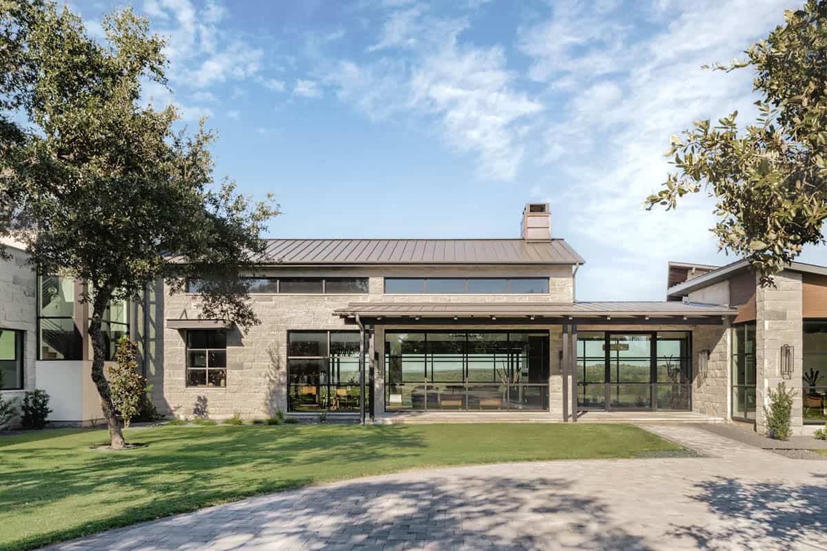  Contemporary ranch home exterior with metal roof, limestone walls and covered porch
