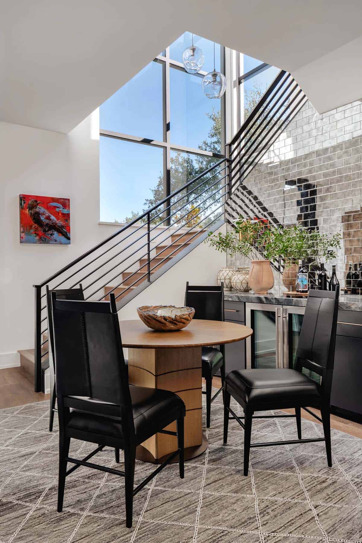 Breakfast nook with modern staircase, wet bar, floor-to-ceiling steel windows and black leather chairs