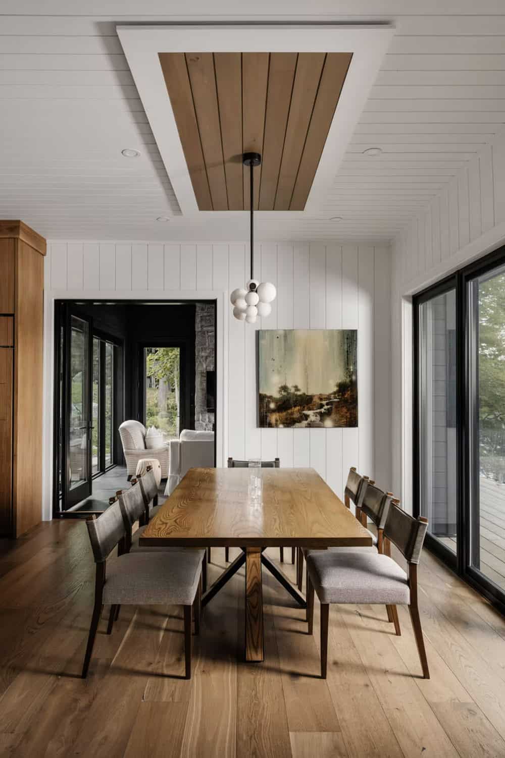 Dining room with solid wood table, wood-inset ceiling medallion, and bubble cluster pendant light
