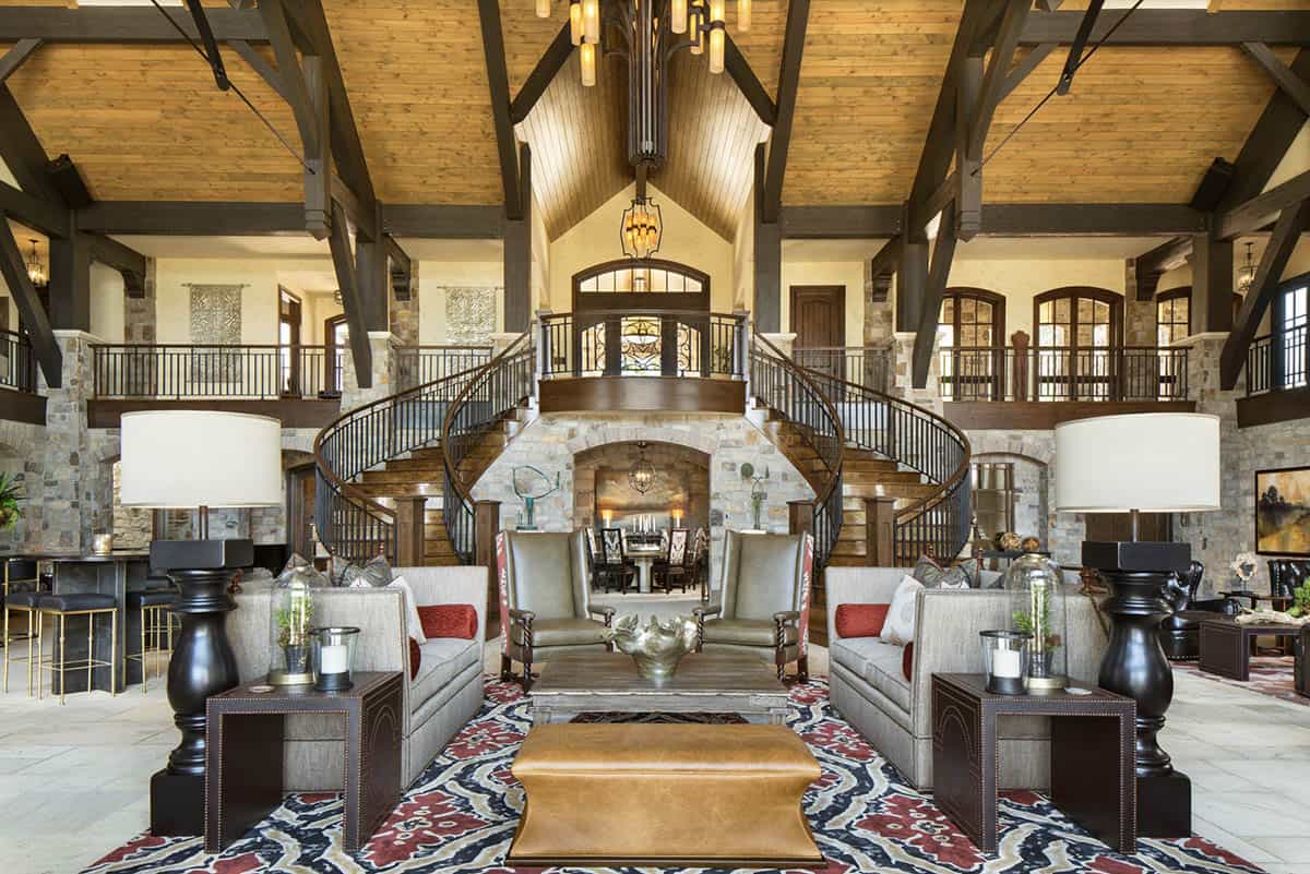 Grand great room with 45-foot wood truss ceilings and dual curved staircases