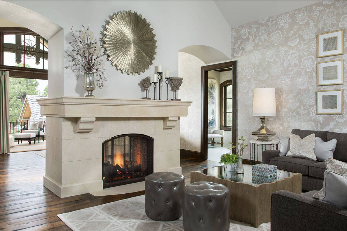 Sitting room with cast stone fireplace, floral wallpaper, and sectional sofa