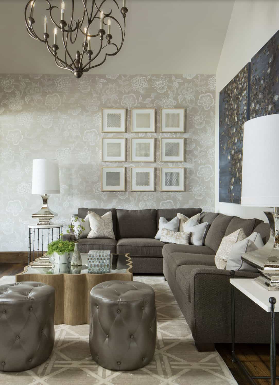 Living room with gray sectional sofa, floral wallpaper, and gallery wall