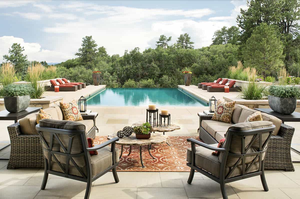 Infinity pool with Rocky Mountain foothills views and outdoor lounge seating