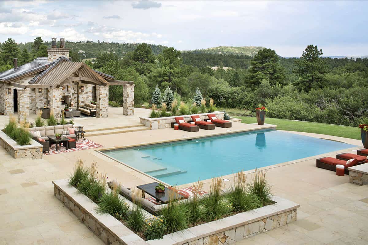 Aerial view of infinity pool, pool house, and landscape views