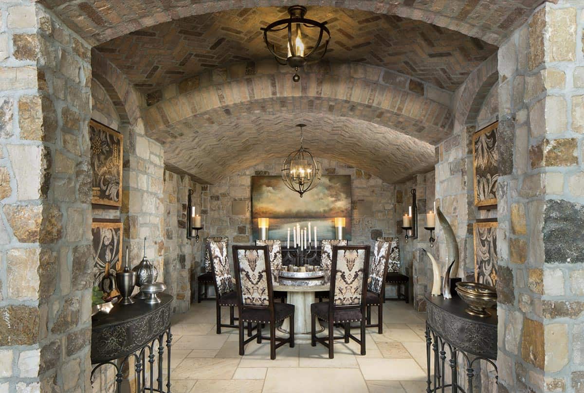 Private wine cellar dining room with barrel-vaulted brick ceiling and round table