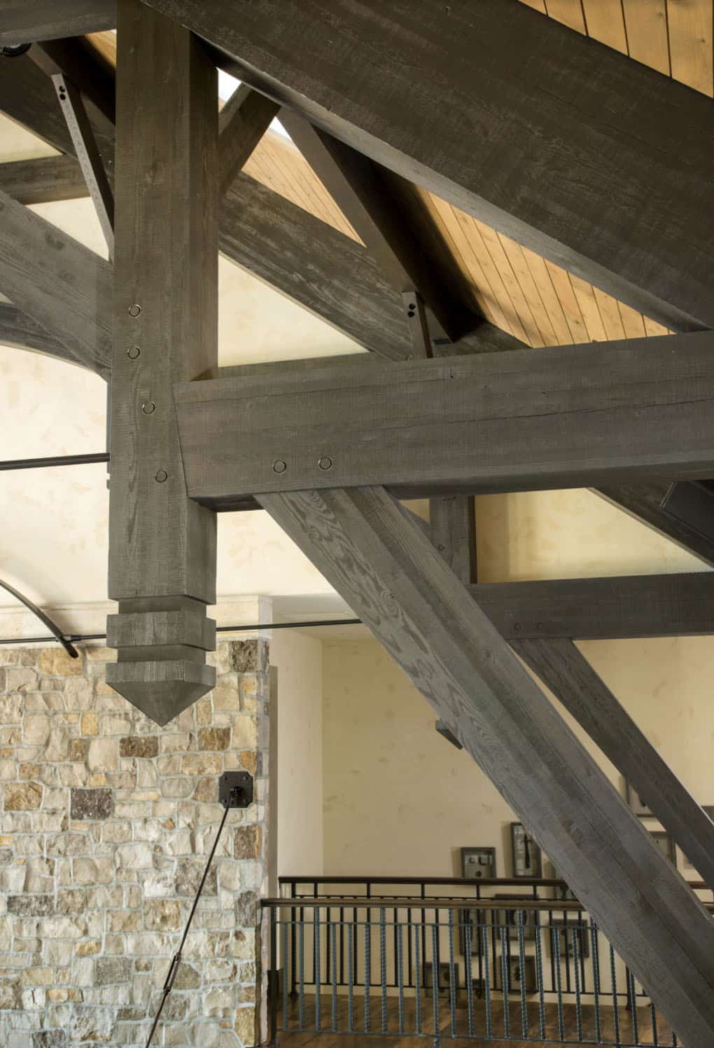 Detail of British Columbia wood truss framework and iron hardware in great room