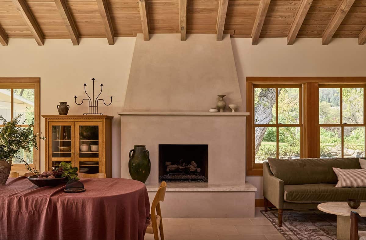 Open-plan living and dining with plaster fireplace and vineyard views