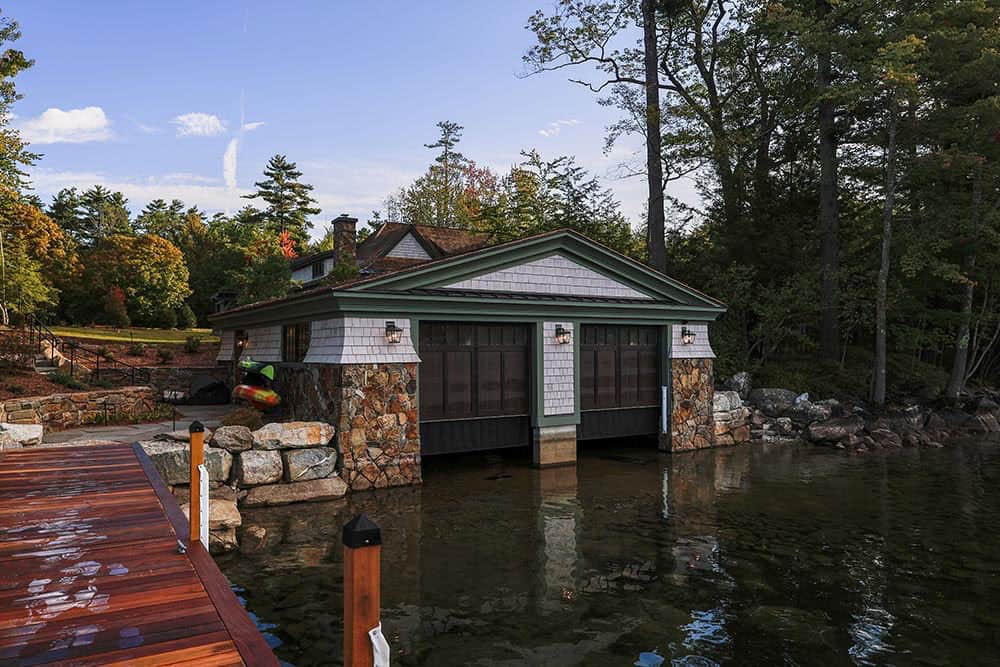 Shingle-style boathouse with stone foundation on Lake Winnipesaukee
