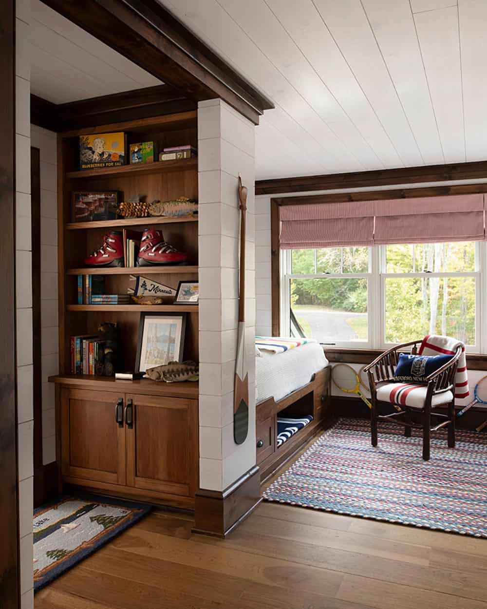 Rustic kids' bedroom with walnut built-ins, camp-style decor, and striped Hudson Bay blanket