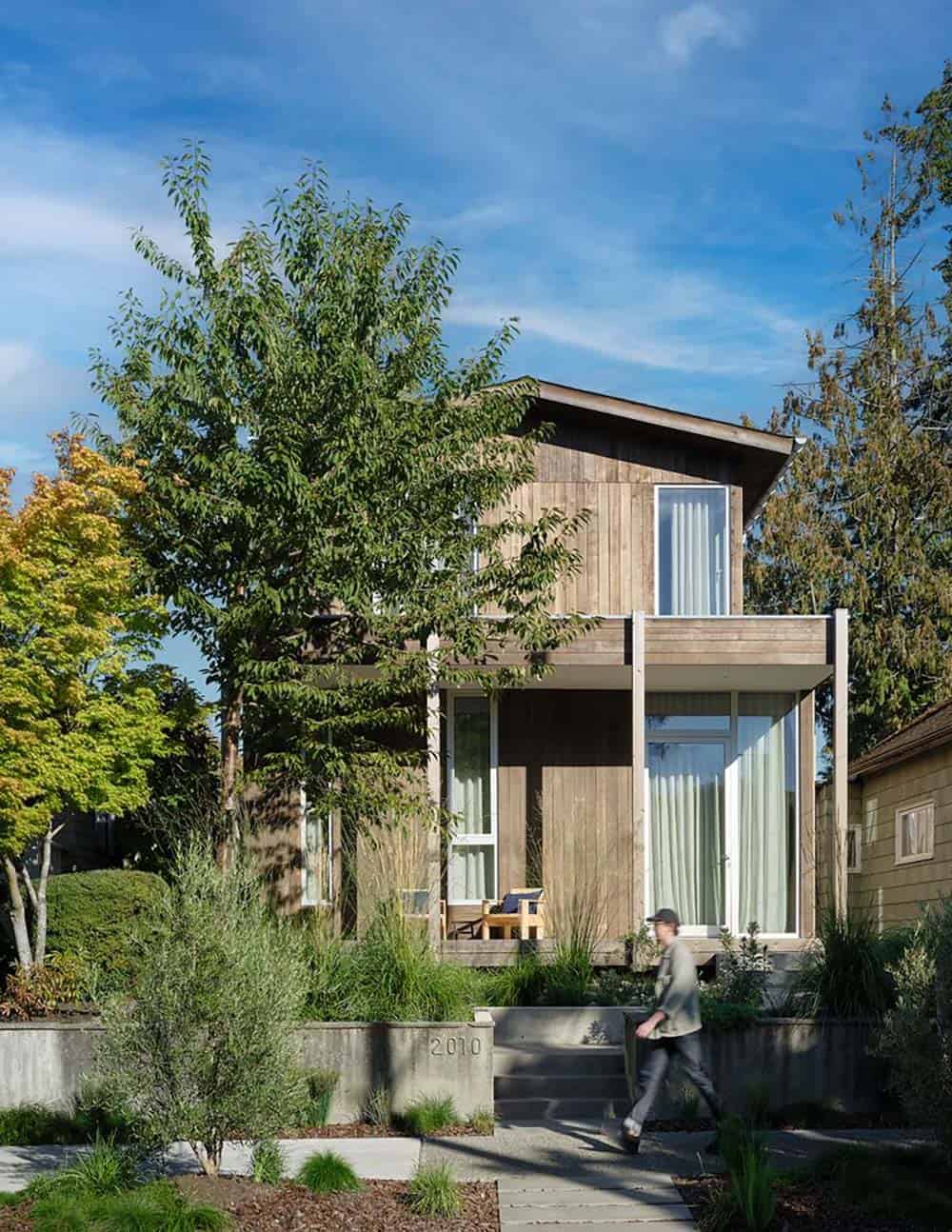Exterior street view of the Madison Park Bungalow with weathered cedar siding and native plantings