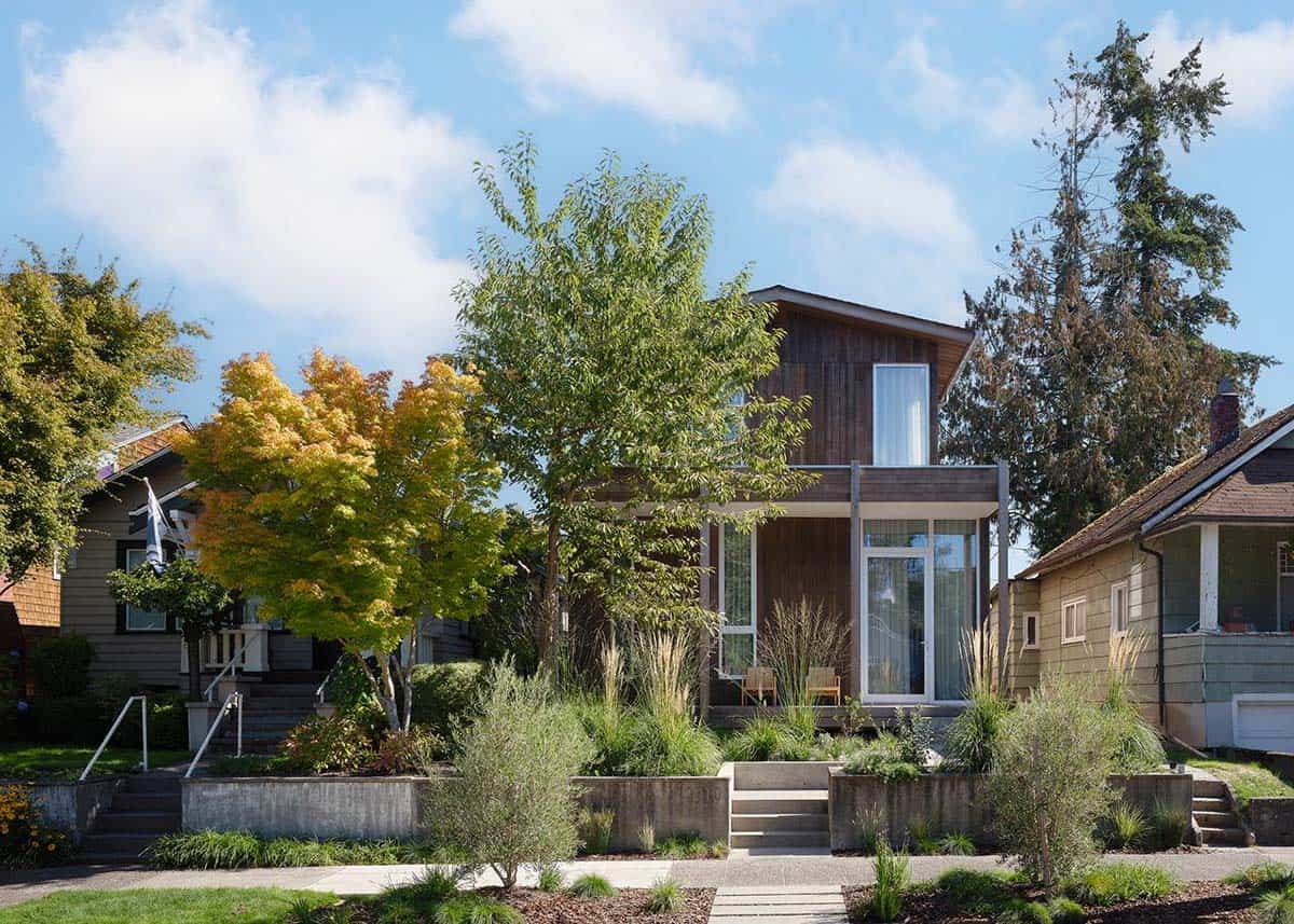 Front facade of the Madison Park Bungalow set among neighboring homes with autumn foliage