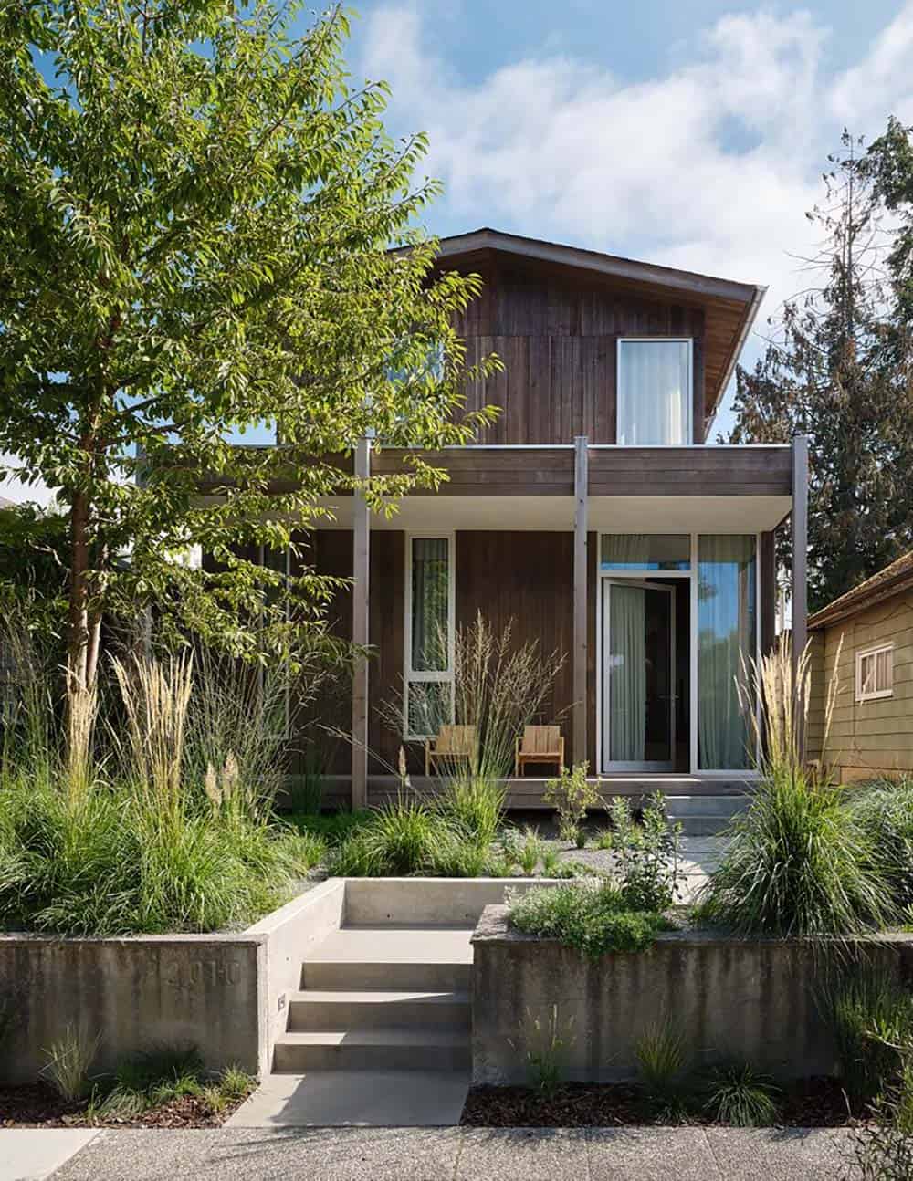 Cedar-clad bungalow with modern front porch and lush native grass garden