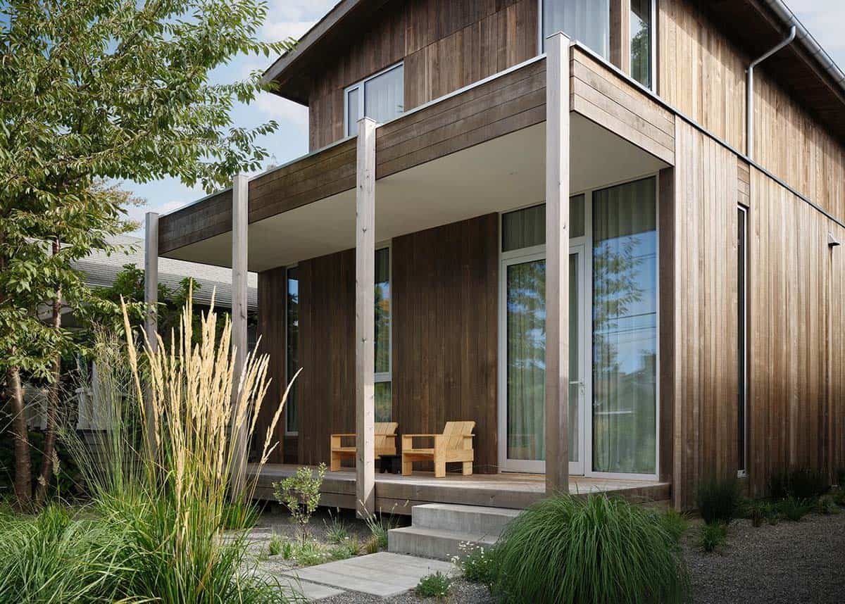 Side view of the covered front porch with custom wood chairs and native garden plantings