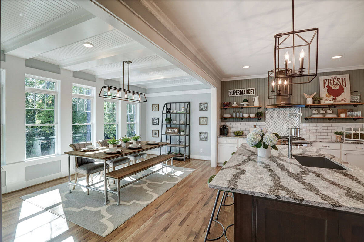 Kitchen and breakfast nook with granite island, subway tile backsplash, open shelving, and large windows