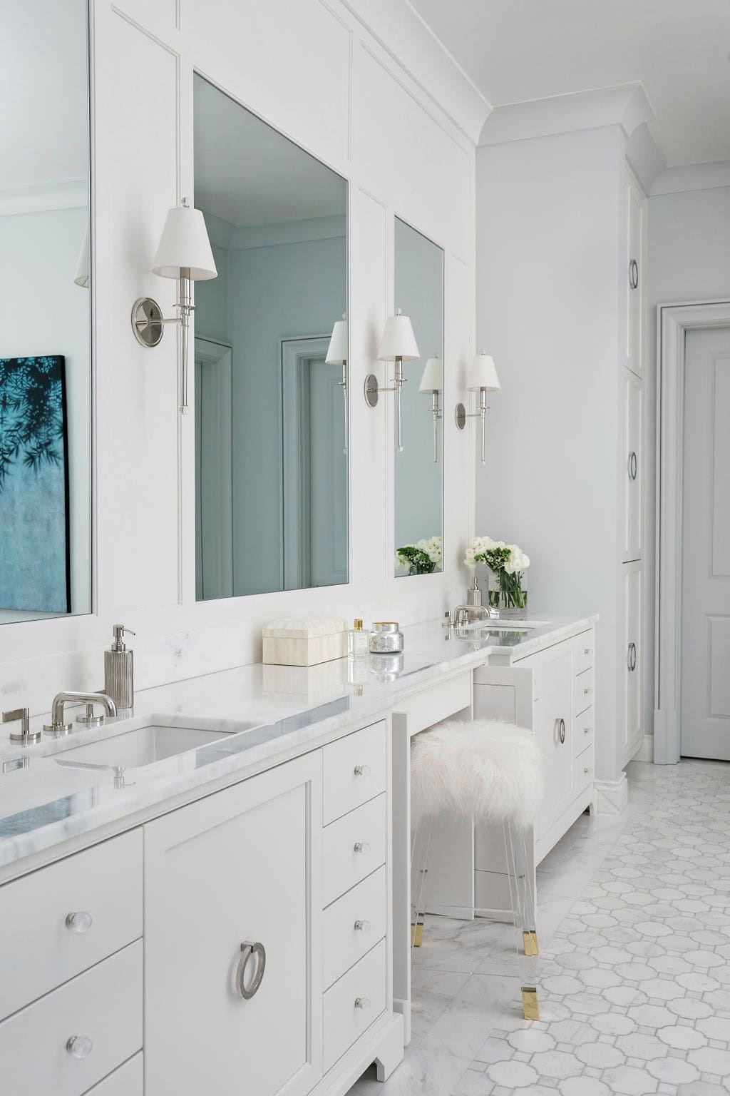 Modern English country primary bathroom with white double vanity, marble countertop, built-in mirrors and mosaic tile floor in Georgia