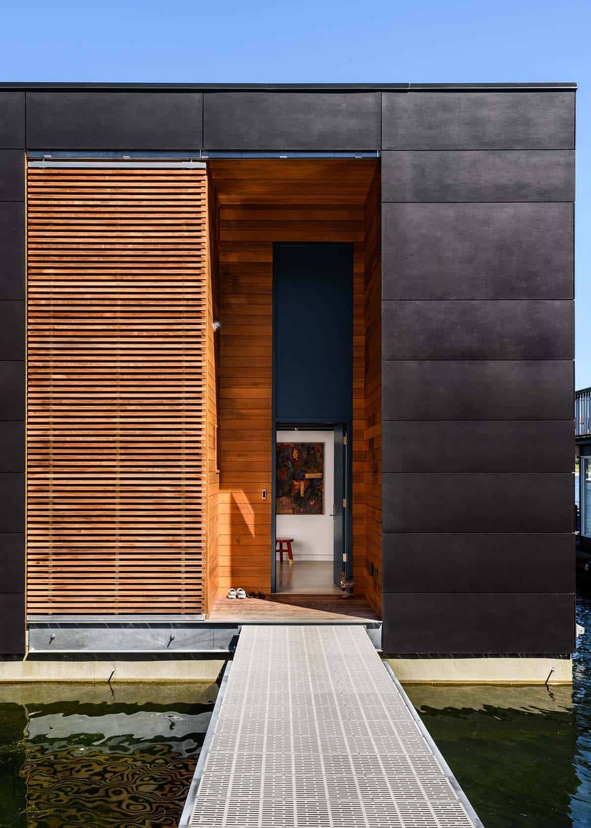 Cedar slatted entry screen and dock walkway of floating home on Portage Bay