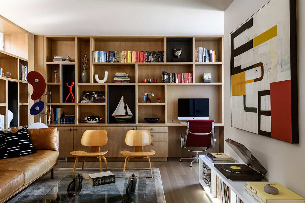 Built-in oak shelving with books and collectibles in floating home study