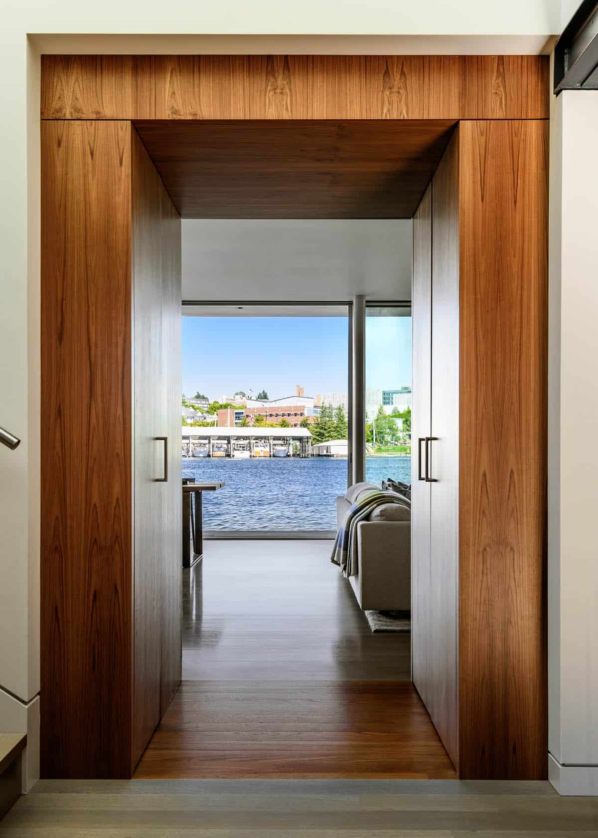 Walnut-framed doorway with water view beyond in Seattle floating home