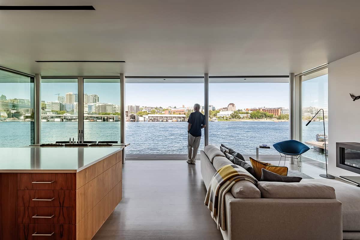 Open-plan living area with panoramic water views and sliding glass doors