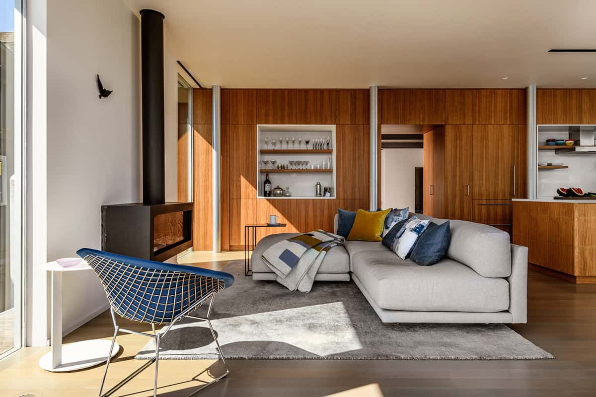 Living room with walnut cabinetry, fireplace, and built-in bar niche
