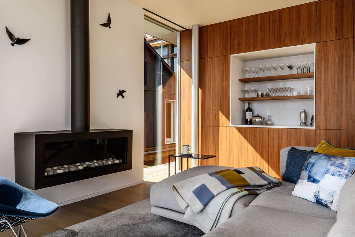 Suspended fireplace and walnut feature wall in floating home living room