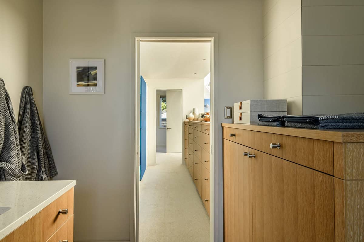 Walk-through dressing room with built-in oak cabinetry in floating home