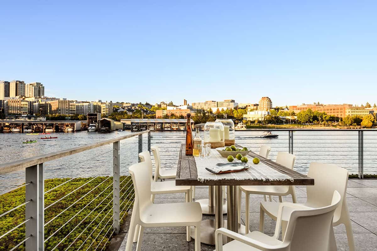 Rooftop dining table with panoramic water and city views on Seattle floating home