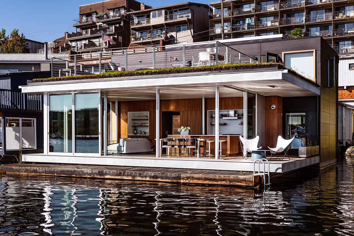 Modern floating home on Portage Bay with green roof, rooftop terrace, and floor-to-ceiling glazing