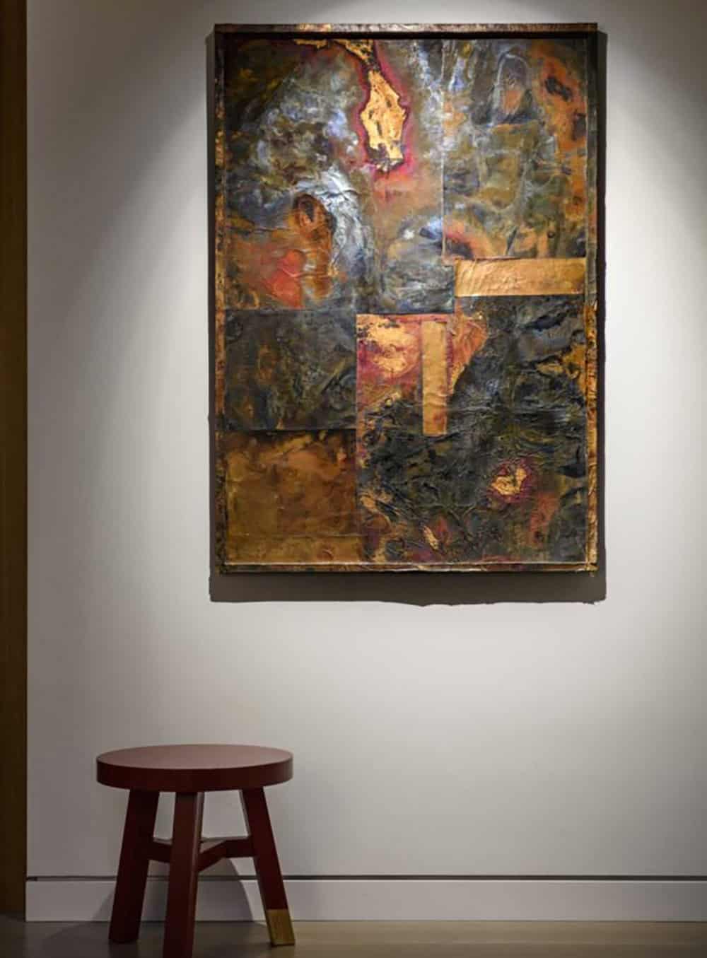 Large-scale abstract mixed media artwork with gold and earth tones displayed in floating home