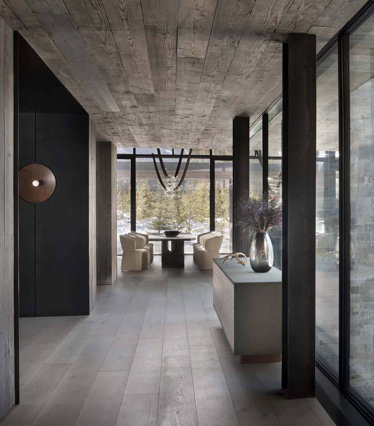 Foyer looking toward dining area with reclaimed wood ceiling, console with vase, and walnut disc pendant