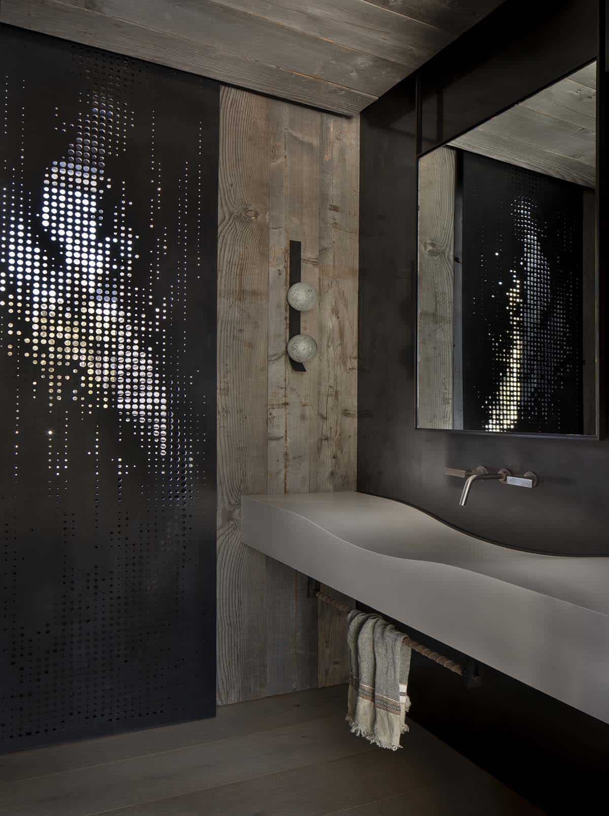 Powder room with perforated black metal screen, reclaimed wood door, floating concrete sink, and wall-mount faucet