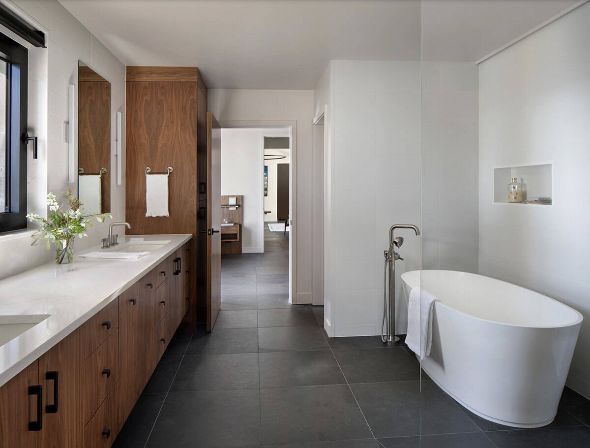 Claude responded: Primary bathroom with walnut cabinetry, white quartz double vanity, freestanding soaking tub, and large-format slate tile floors.Primary bathroom with walnut cabinetry, white quartz double vanity, freestanding soaking tub, and large-format slate tile floors