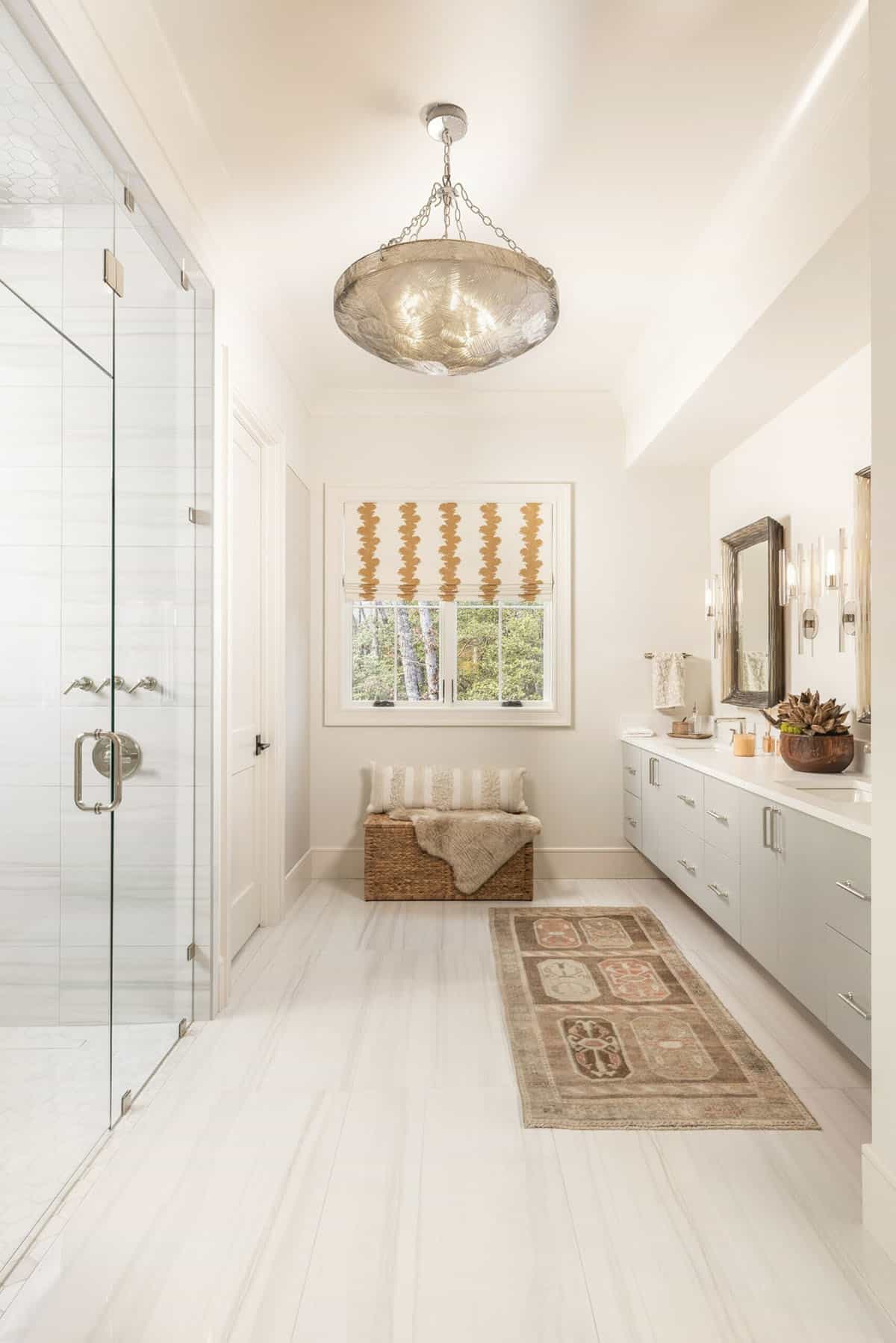 Spa-style primary bathroom with floating vanity, vintage runner rug, and shell chandelier