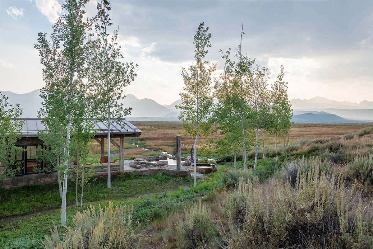 Outdoor soaking area at Springs Ranch in Stanley Idaho with aspen trees and Sawtooth Mountain views