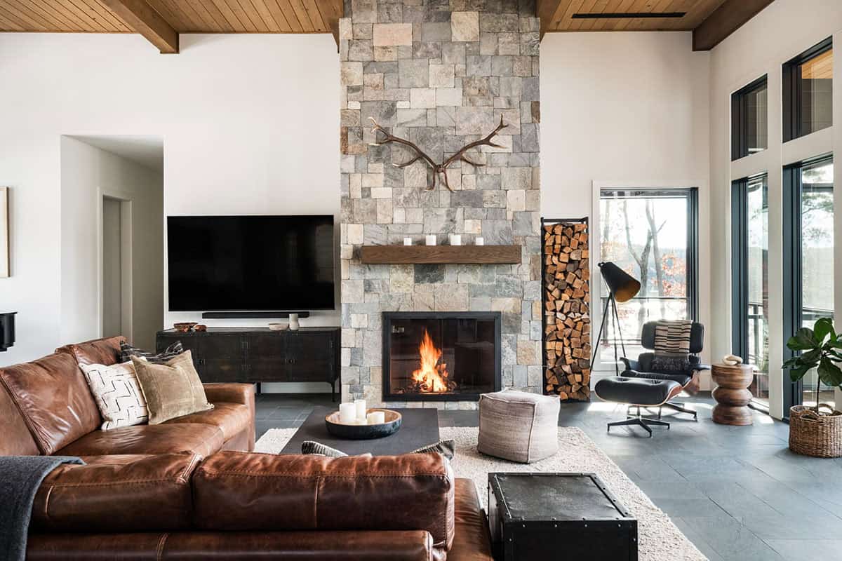 Living room with floor-to-ceiling stacked stone fireplace and antler decor