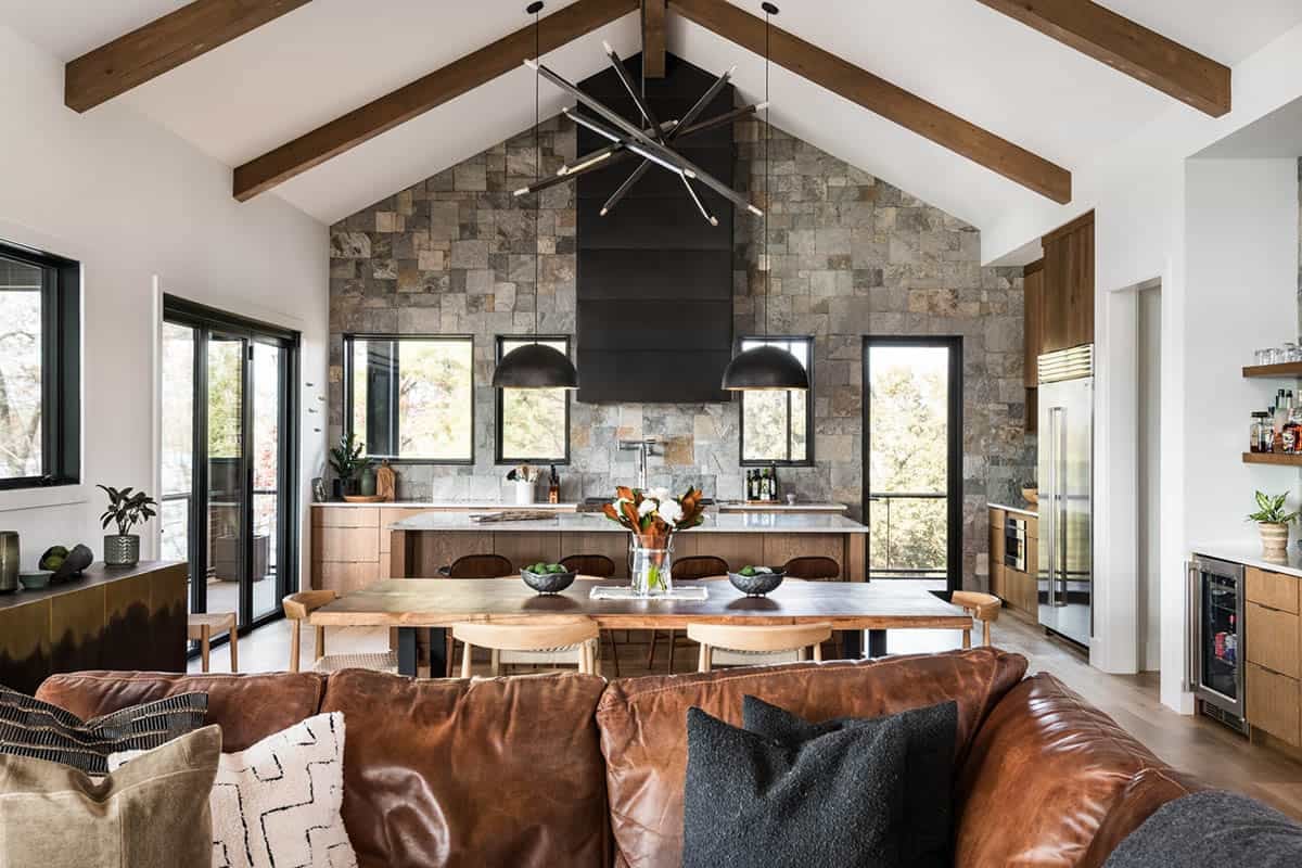 Open-plan dining and kitchen area with vaulted wood-beam ceiling