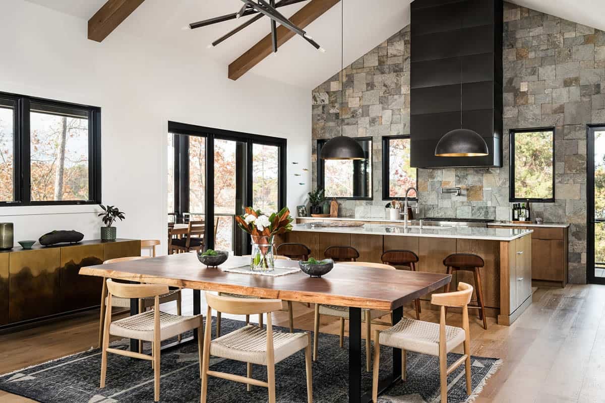 Dining table with live-edge wood top beneath stone accent wall
