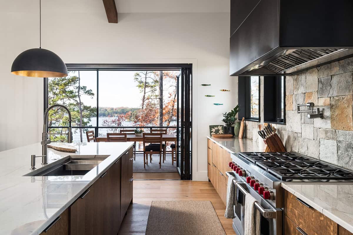 Galley kitchen view toward dining area with lake visible through windows