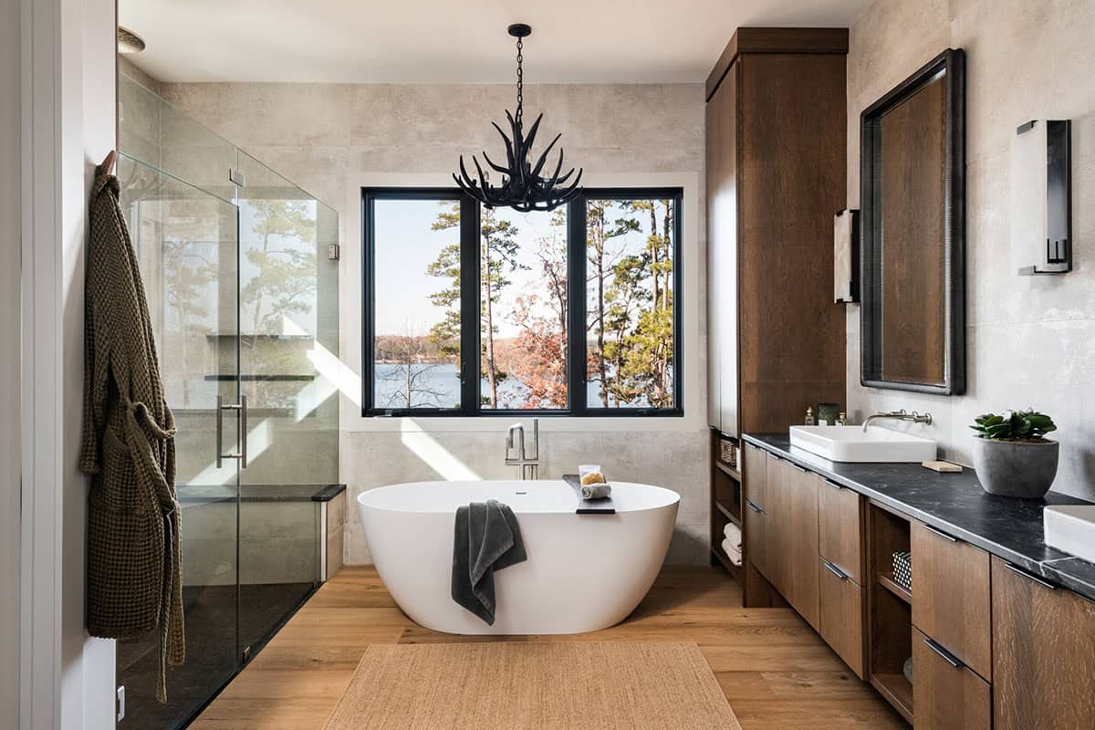 Primary bathroom with freestanding tub and antler chandelier