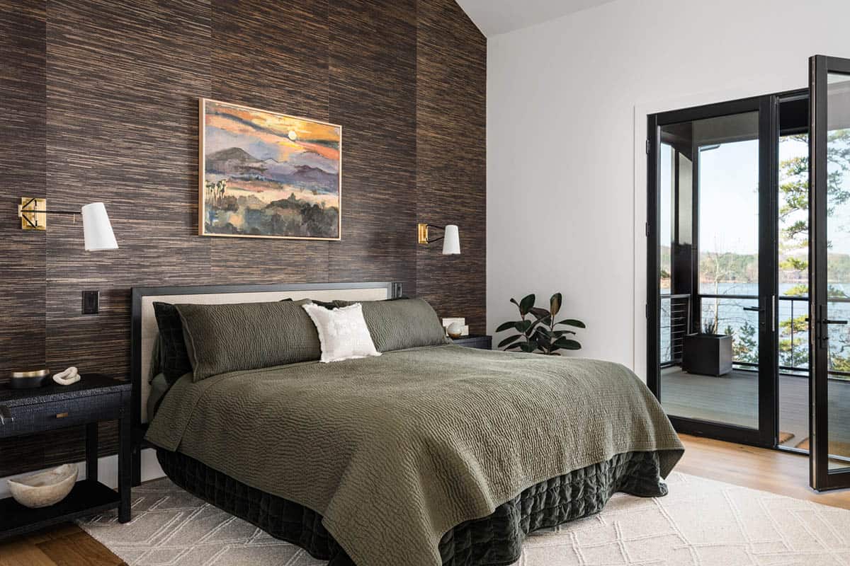 Bedroom with dark wood accent wall and private balcony access