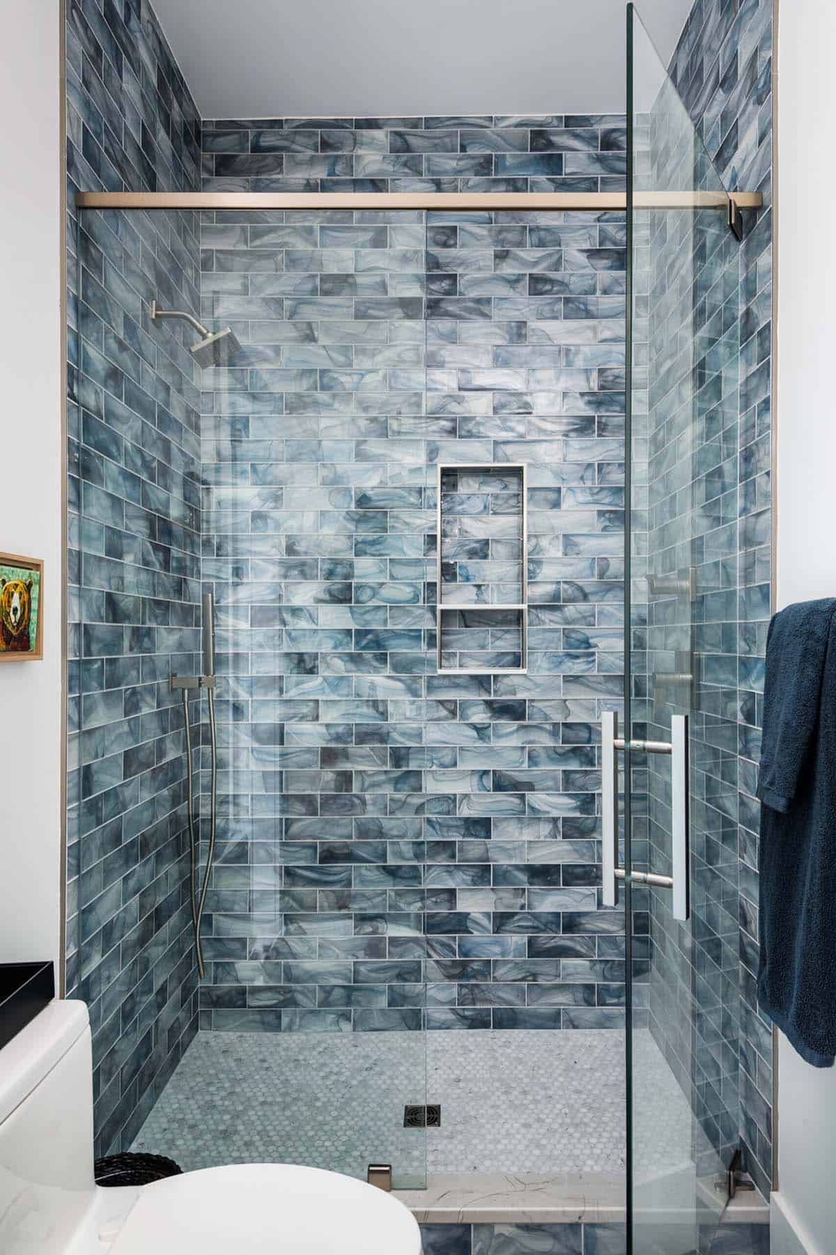 Walk-in shower with blue marbled glass tile