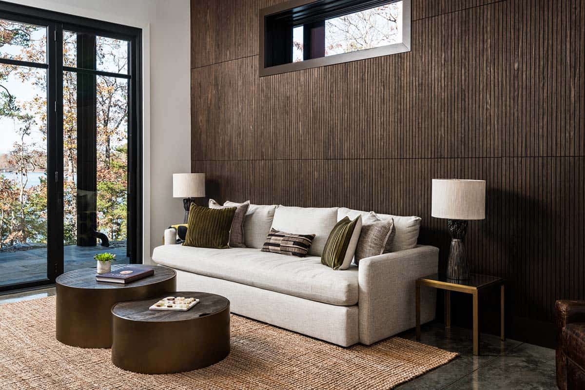 Family room with slatted wood accent wall and round bronze coffee tables