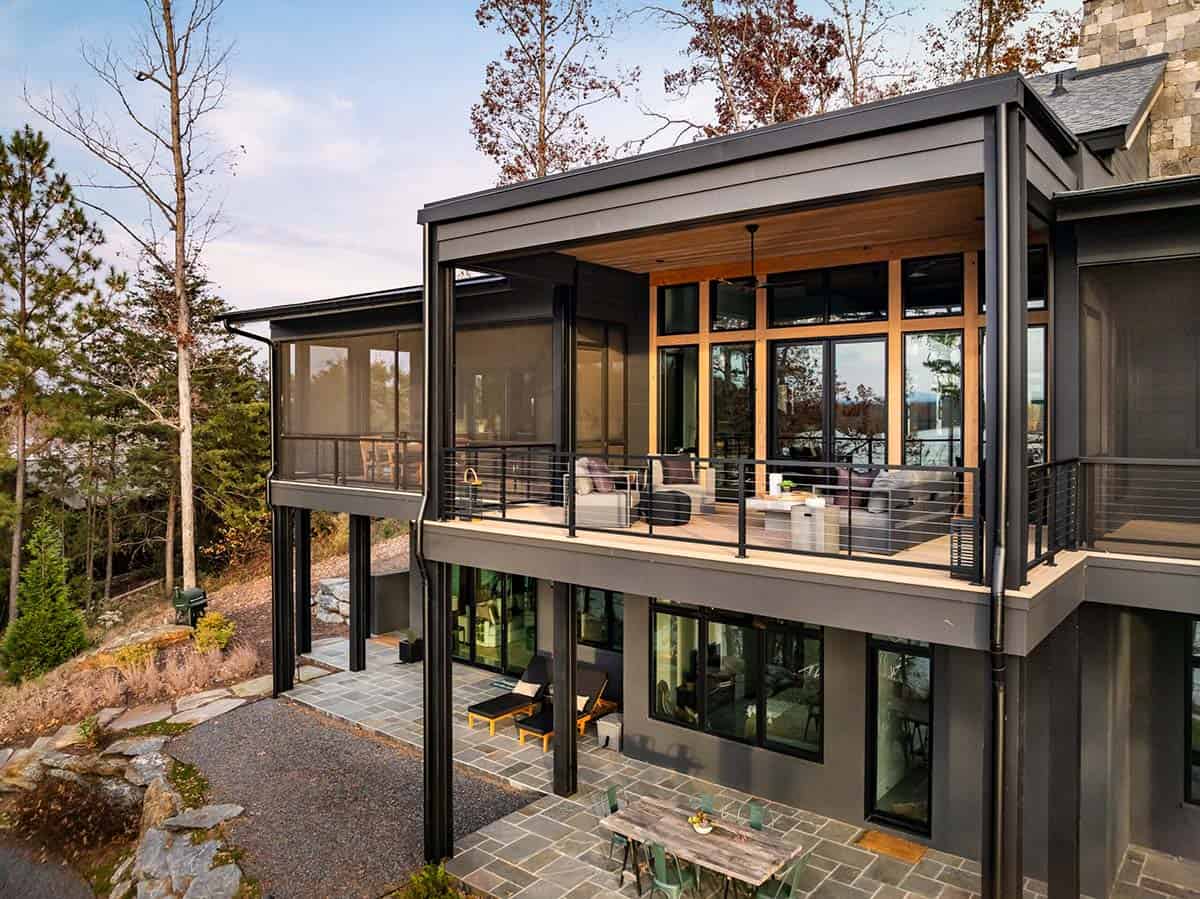 Exterior view of cantilevered black-framed screened porches and deck