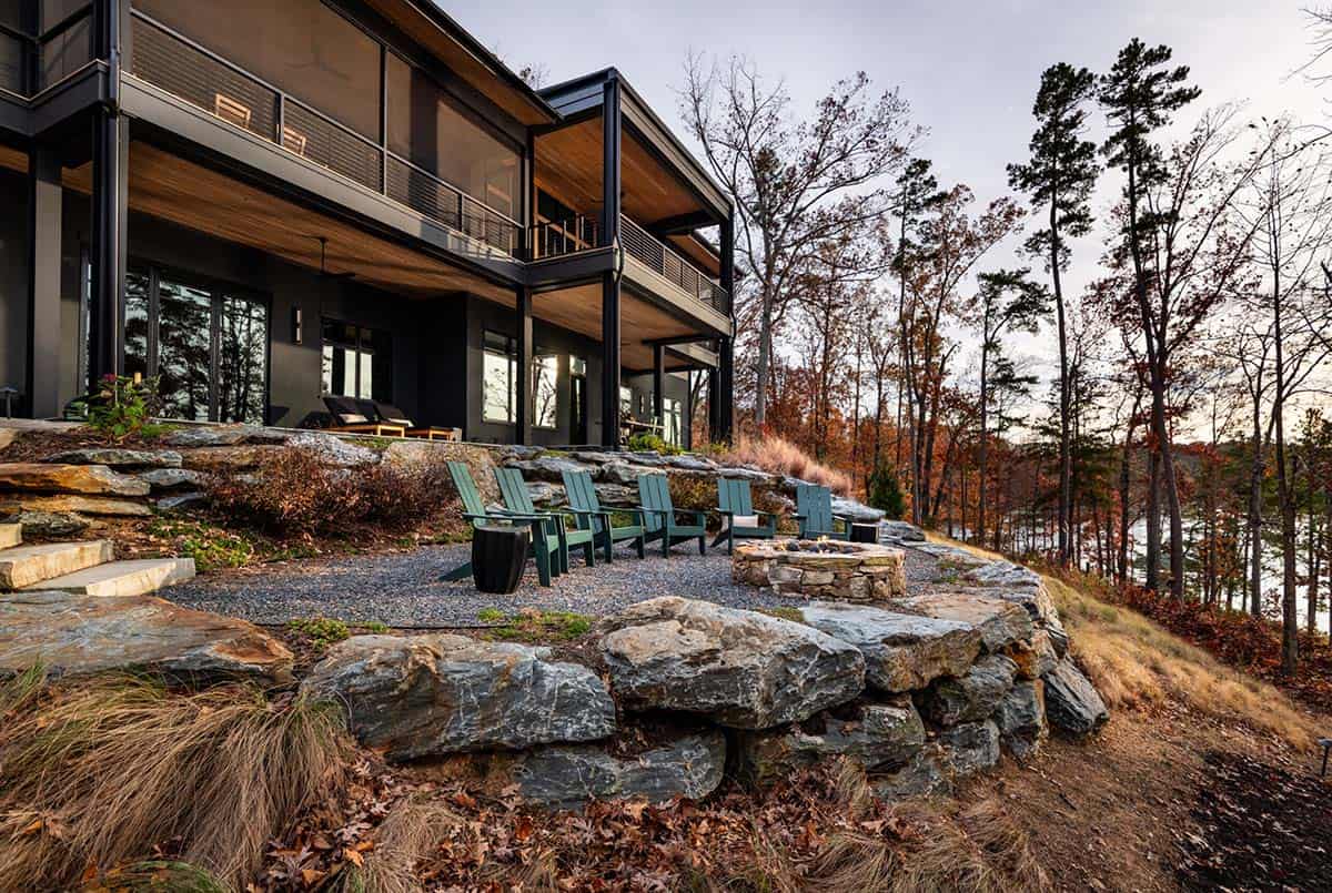 Rear patio with stacked stone fire pit and Adirondack chairs at dusk
